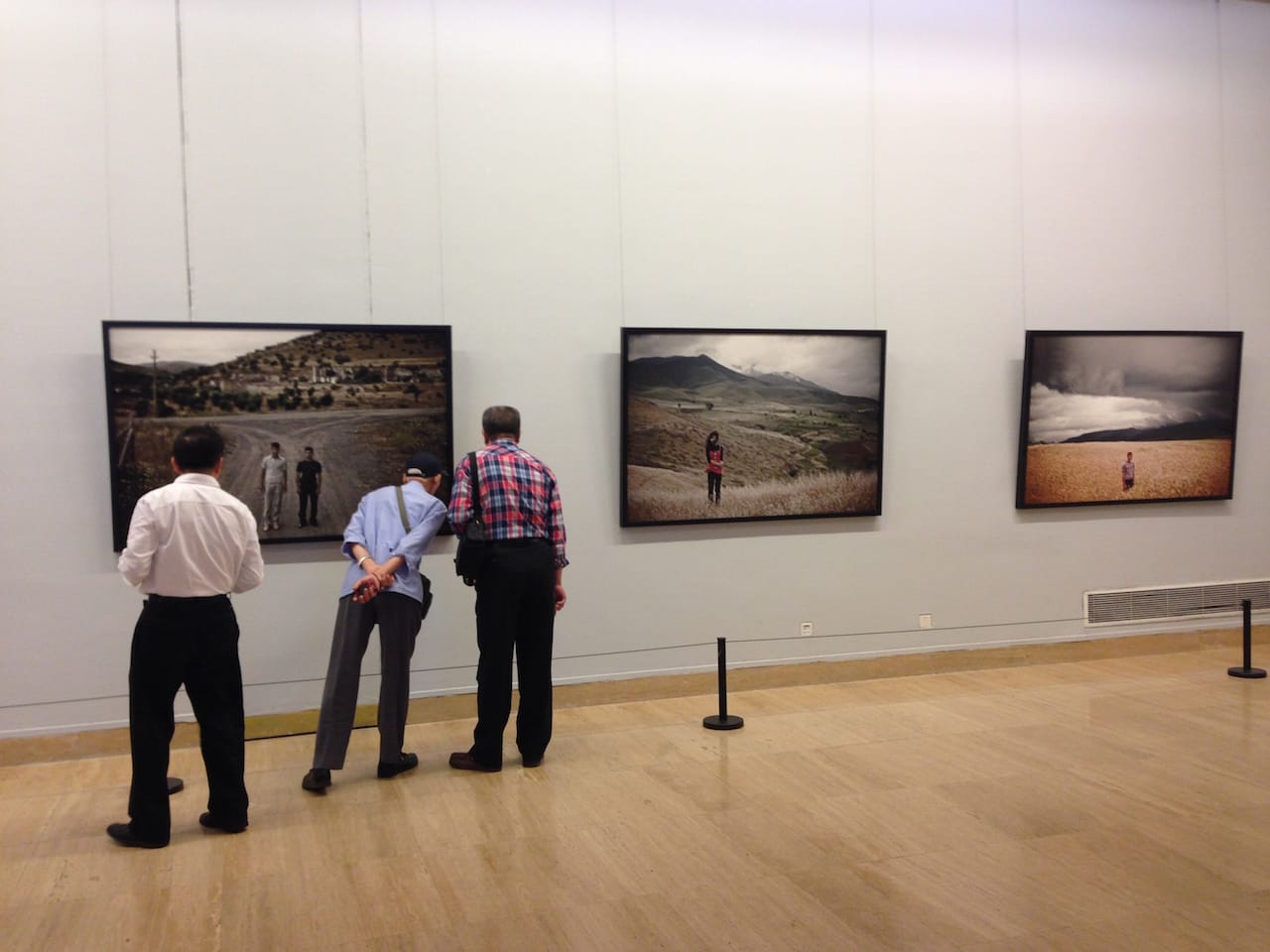 Visitors to the Armenian special exhibition examine photographs by Karen mirzoyan (photo by Anna Gargarian)