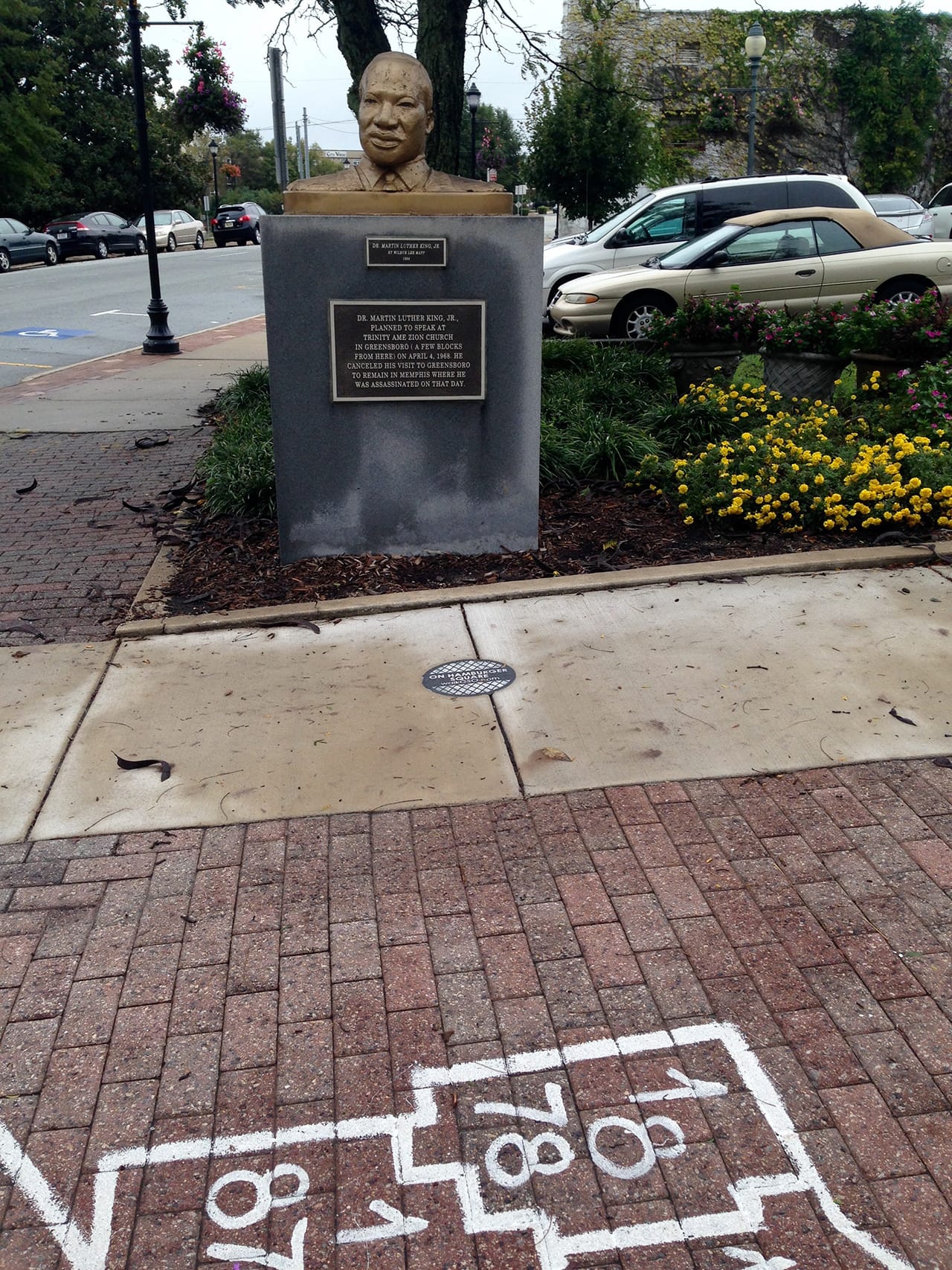 Possibly the world's only historic plaque commemorating an event that never happened: Martin Luther King, Jr.'s missed visit to Greensboro. South Elm projects by Agustina Woodgate and Samara Smith also in view. (all photos by the author for Hyperallergic)