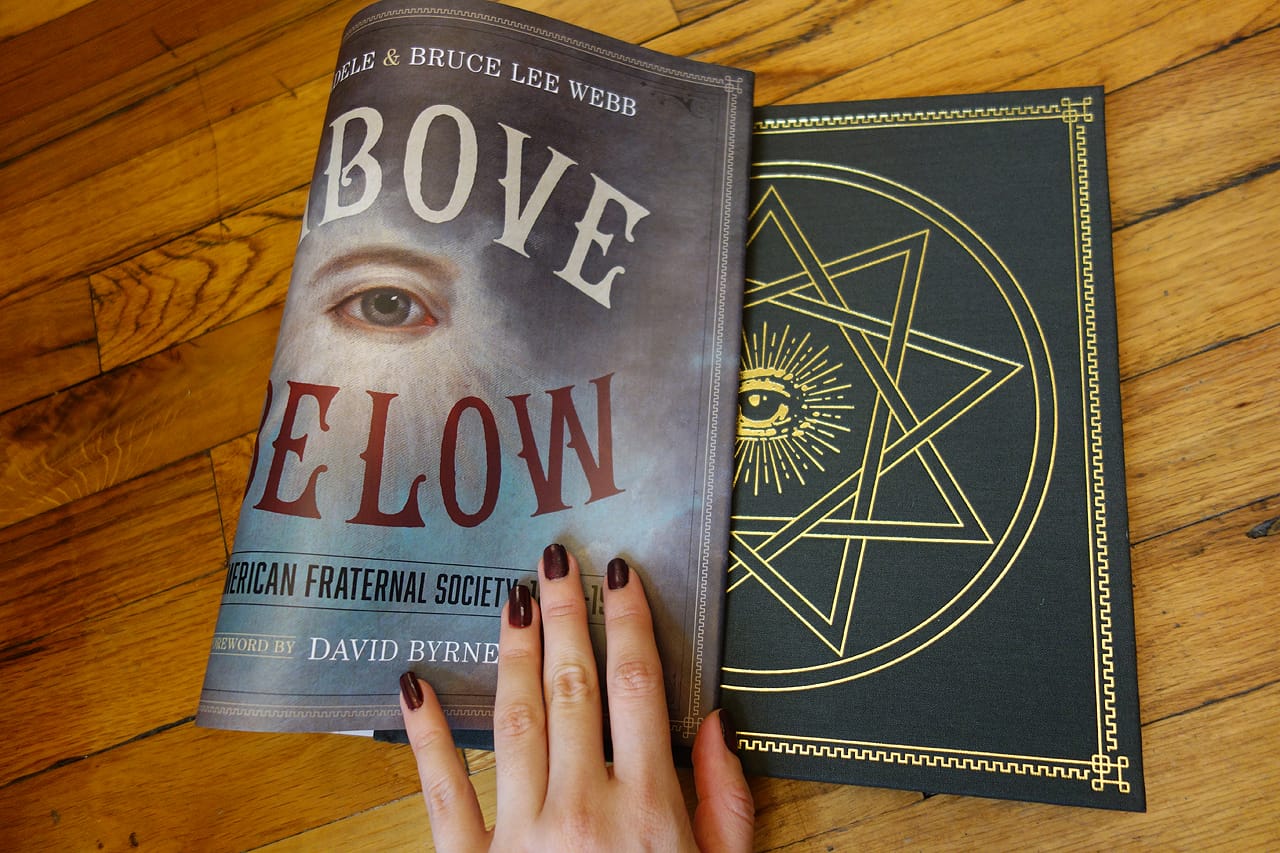 All seeing eye hidden behind the dust jacket of 'As Above So Below' (photo of the book for Hyperallergic)