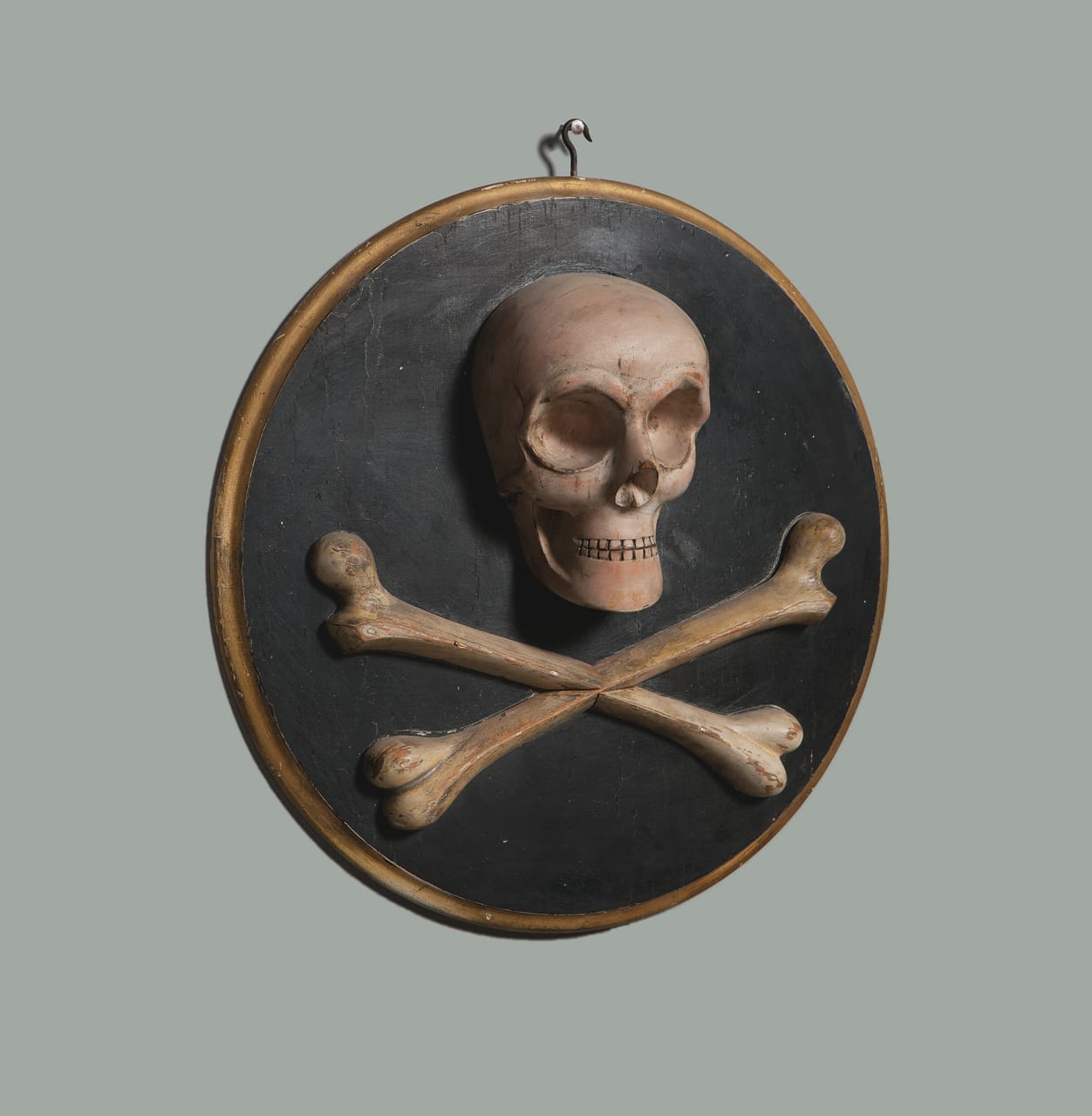 Odd Fellows skull and crossbones plaque (1870s), unknown maker, possibly M. C. Lilley & Co., carved and painted wood, 16 in. diameter (courtesy Webb Collection)