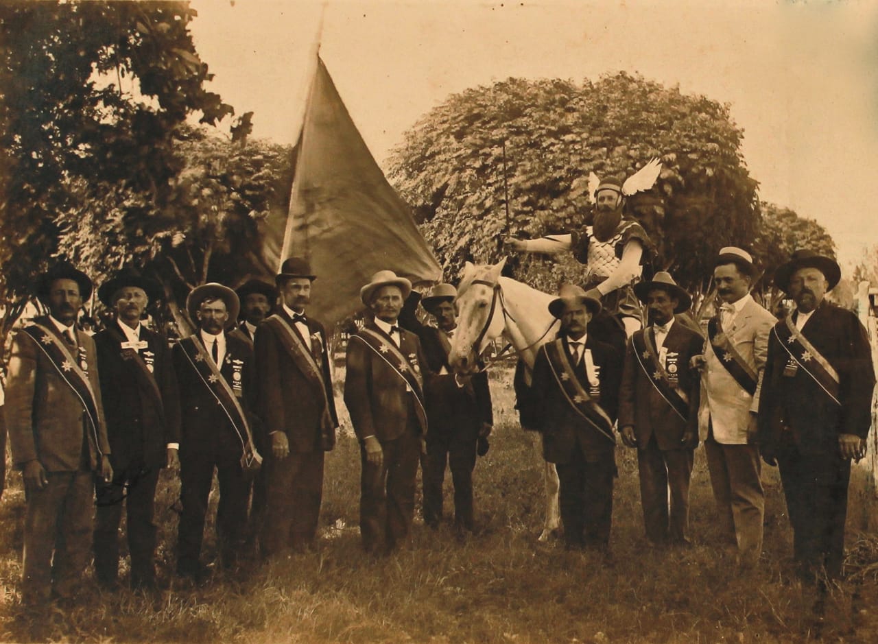 Sons of Hermann lodge members dressed for a parade, Shiner, Texas (1909). The man on horseback is wearing a Thor costume. (courtesy Webb Collection)