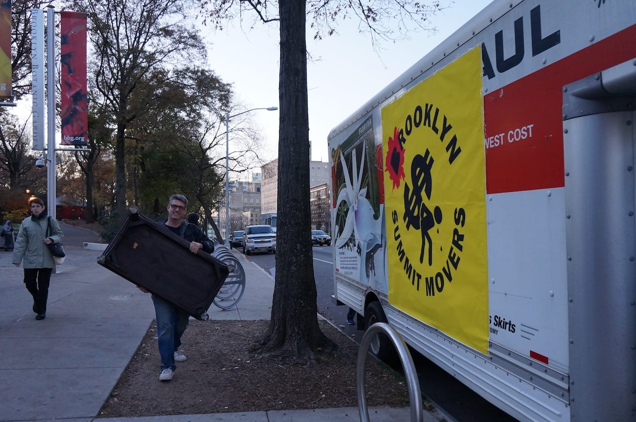 "Movers" unloaded furniture and other items from a U-haul truck.