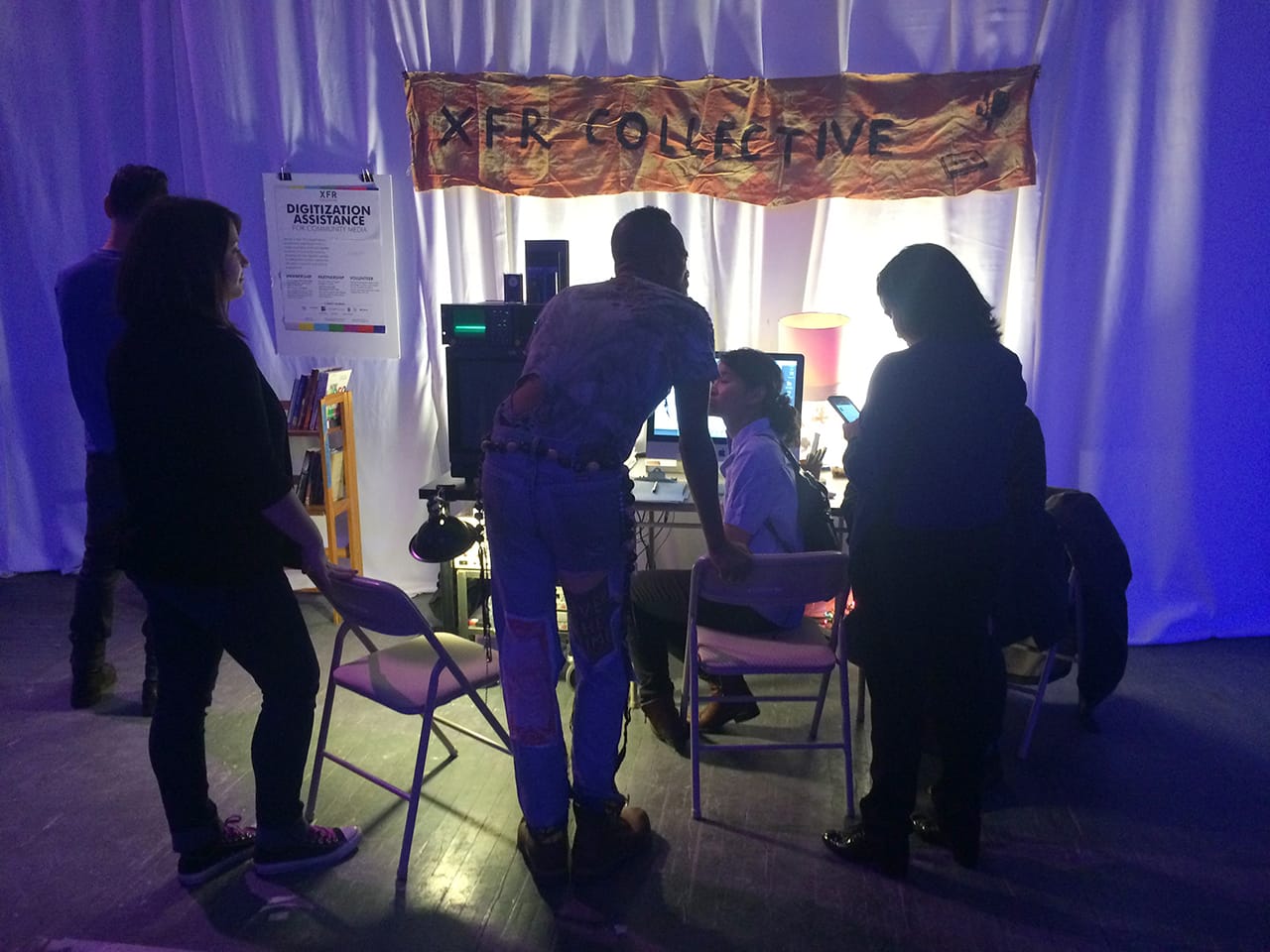 A visitor talks with XFR Collective members.