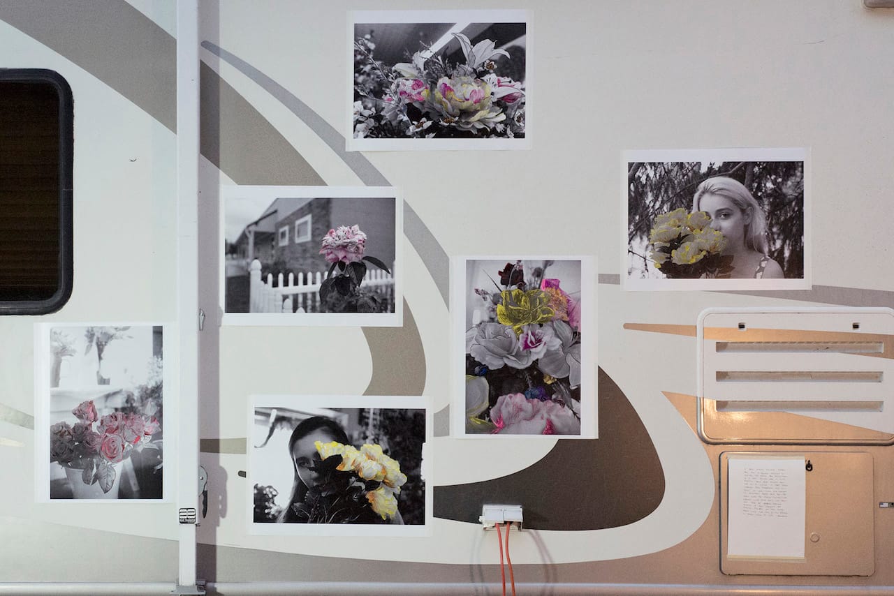 A student’s handpainted photographs displayed on the side of the RV during a “pop up” exhibition.