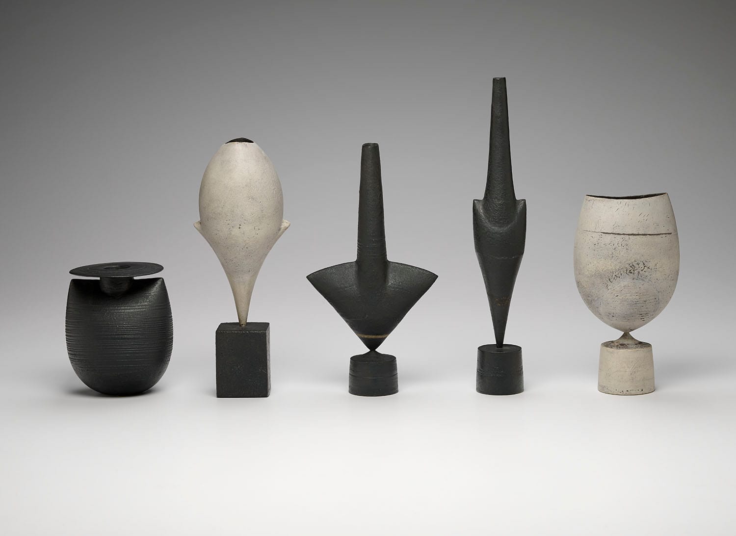 Hans Coper, Bottle with Disc and 4 Cycladic forms (ca. 1970–75), stoneware, ranging from 4 1/2 × 3 3/4 × 3 1/2 in to 11 3/4 × 2 × 1 3/4 in