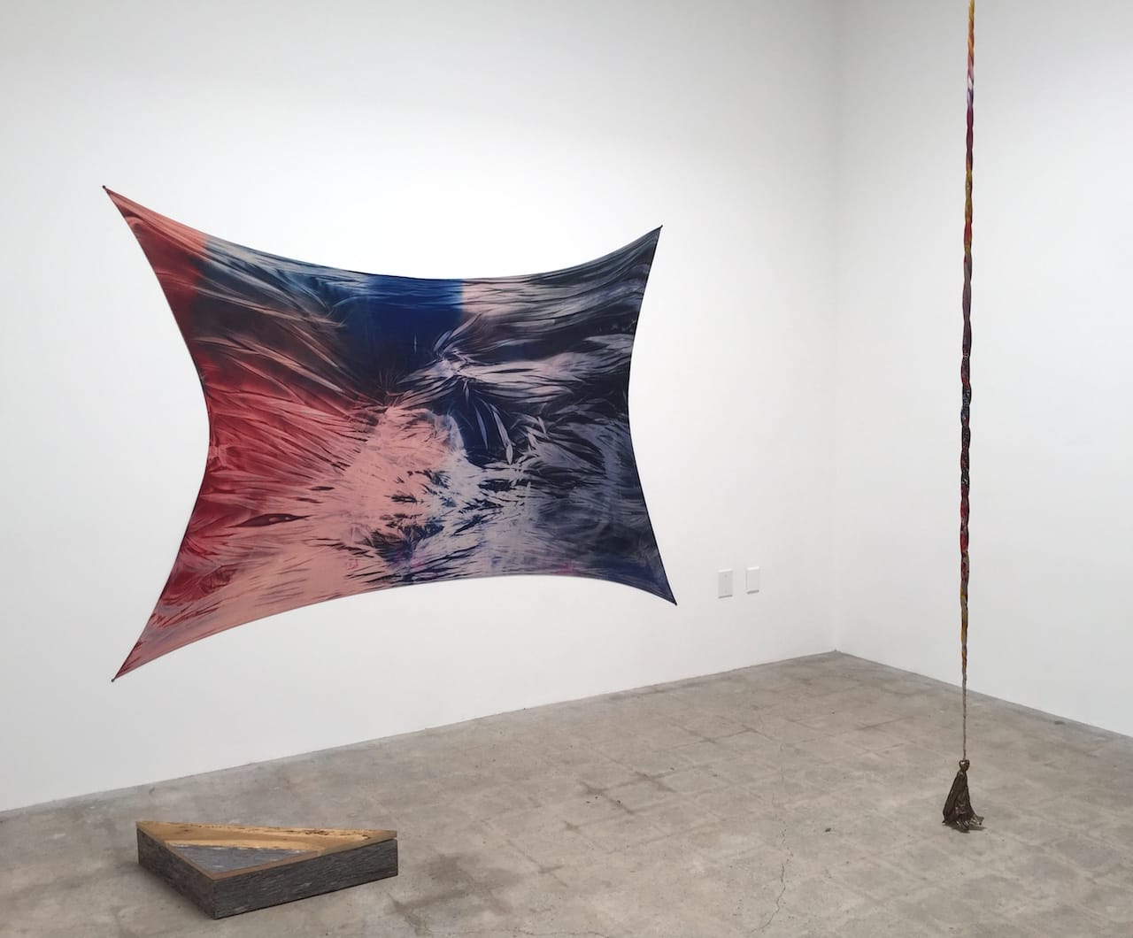 Installation view of April Street's 'Lay Down Your Arms' with "Wandering Limb #14" (2015, left), acrylic on hosiery and reclaimed wood, 68 x 92 in.; and "Magicians Rope" (2015, right), hosiery, acrylic paint, and bronze, 98 x 4 x 2 in.