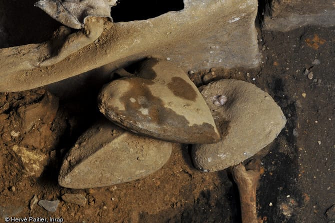 Lead heart-shaped lead urns unearthed at the excavation site (photo by Hervé Pattier)