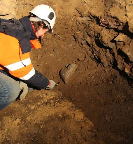 Archeologist, Dr. Rozenn Colleter, excavating the fifth heart-shaped lead urn. Image by Gaétan LeCloire/INRAP