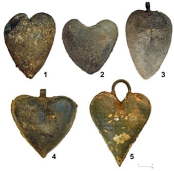 Picture of the five heart-shaped lead urns. Image by Rozenn Colleter, Ph.D./INRAP