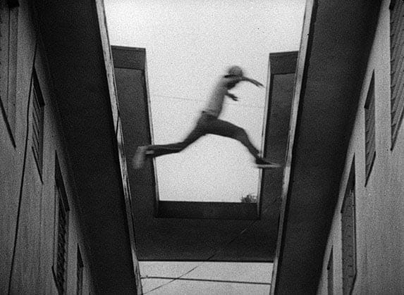 Neighborhood kids jumping from roof to roof in the film KILLER OF SHEEP, a Milestone Film & Video release.