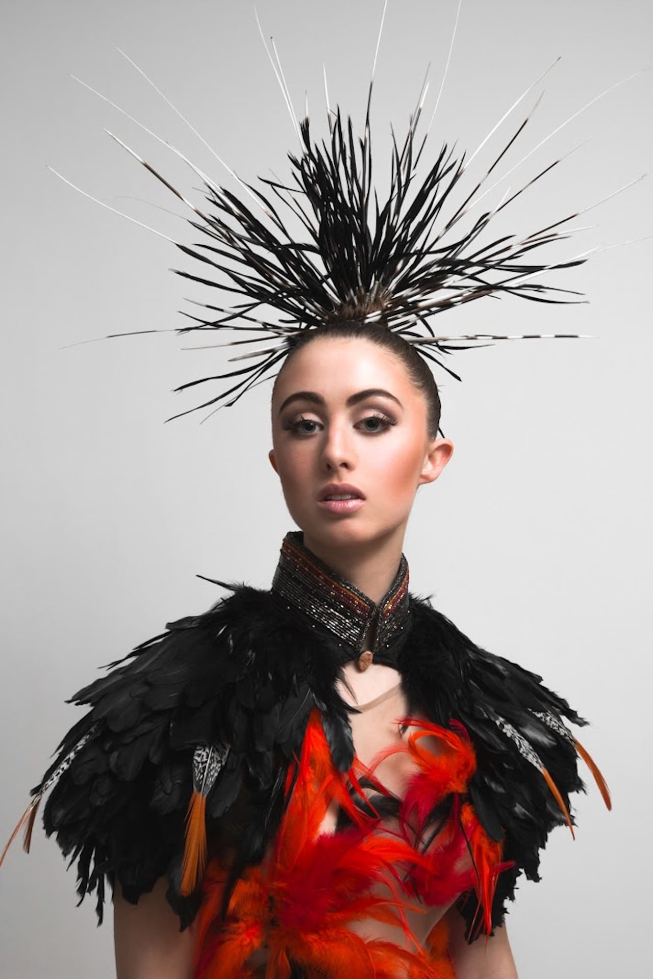 Orlando Dugi (Diné [Navajo]), cape and dress from “Desert Heat” Collection (2012) (detail), paint, silk, organza, feathers, beads, and 24k gold (photo by Thosh Collins)