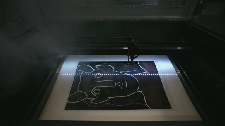 Picasso underneath a laser (screenshot <a href="https://vimeo.com/148548977" target="_blank">via Vimeo</a>)