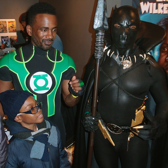 Boy poses with Green Lantern and Black Panther at the Black Comic Book Festival (all photos by the author for Hyperallergic)