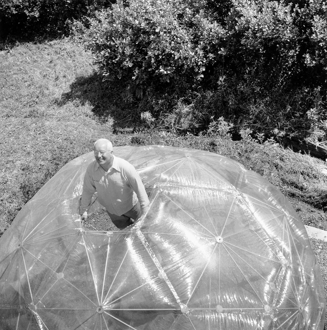 Hazel Larsen Archer, "Buckminster Fuller inside His Geodesic Dome" (1949), gelatin silver print, 9 ½ x 9 ¼ in, Estate of Hazel Larsen Archer and Black Mountain College Museum and Arts Center