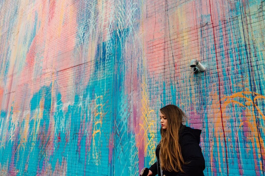 Artist Katherine Craig in front of her work "The Illuminated Mural" (photo by Trilogybeats)