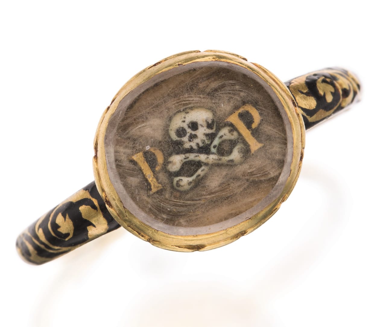 Enameled gold mourning ring (late 17th century), with an applied skull and crossbones between initials PP on hairwork beneath glass, the band with foliage on black enameled ground.