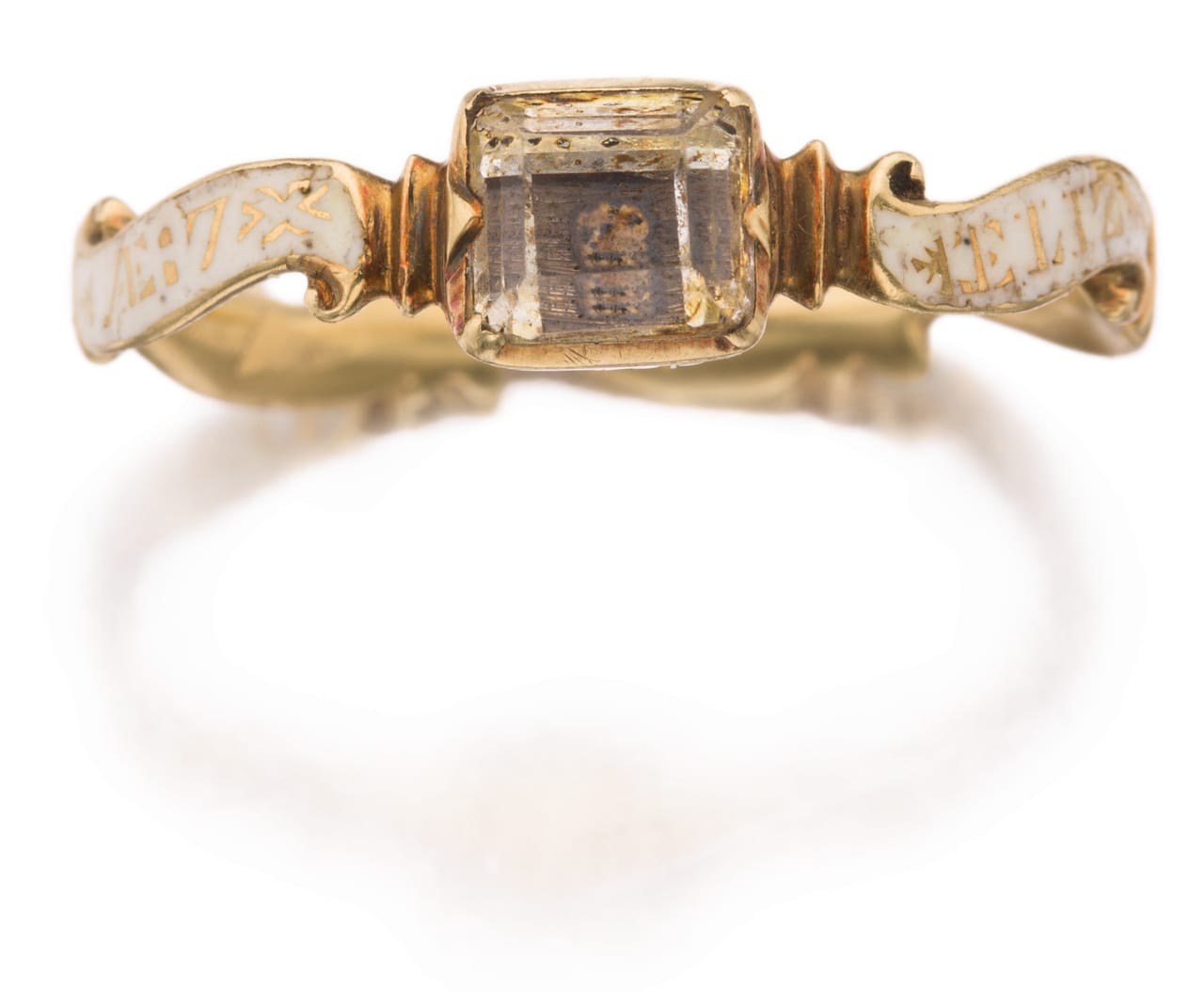 American enameled gold mourning ring, attributed to Thomas Edwards (1747, Boston), mounted with a table cut crystal over a painted skull, the shaped band with inscription "ELIZ ROYALL OB:2: JULY 1747 AE: 7" on white enamel ground.