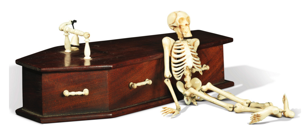 Momento mori mahogany coffin with fully articulated bone skeleton (19th century), bone bell and pull attached to the lid of coffin, 7 5/8 x 3 1/4 x 3 inches.
