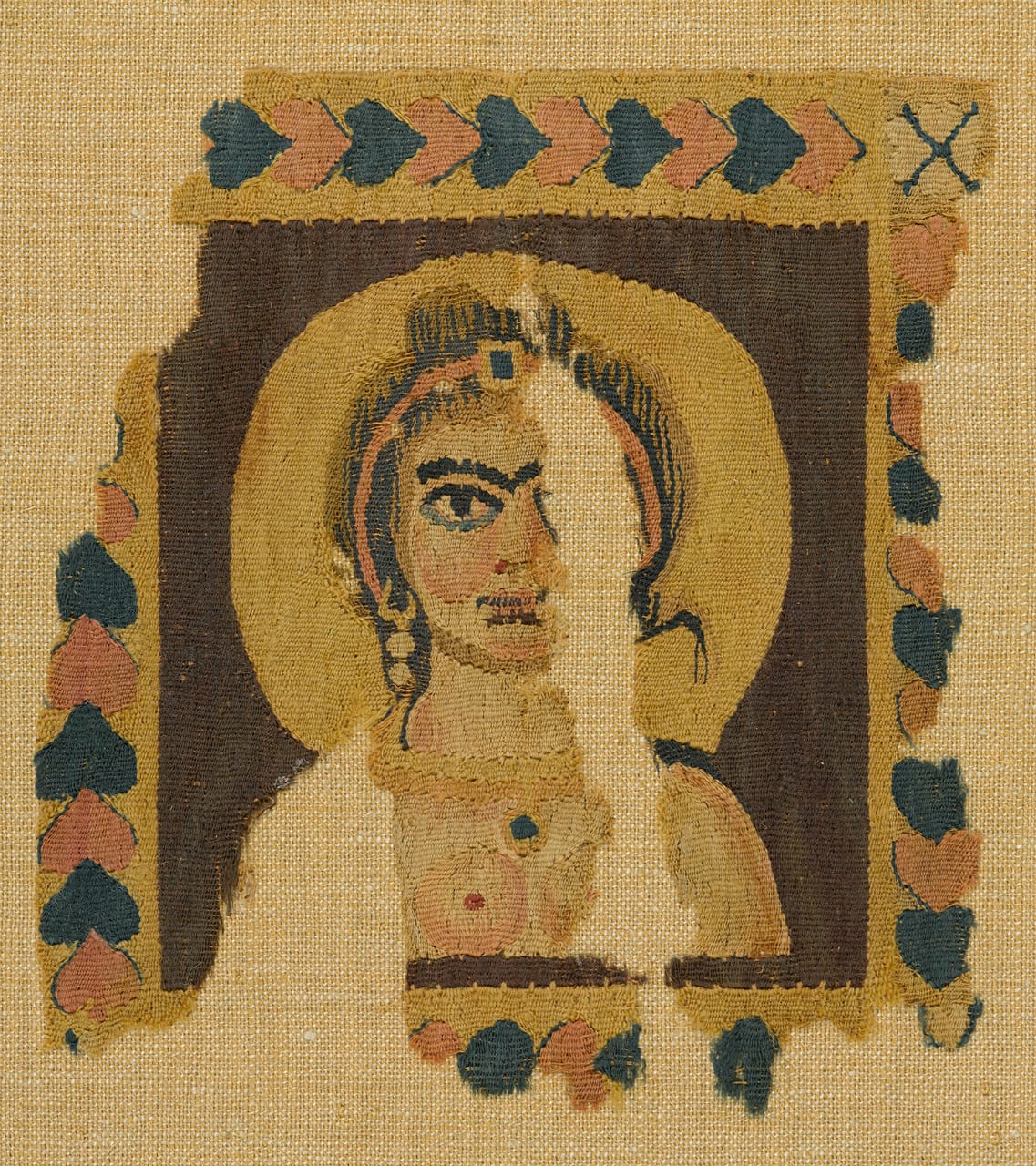 Square panel from a garment or furnishing with bust of a female figure, tapestry weave of dyed wools (and possibly undyed linen) (Egypt, 5th-6th century CE) (© Brooklyn Museum, photo by Sarah DeSantis)