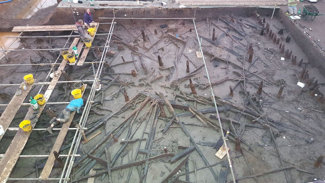 Archaeologists at Must Farm have uncovered the charred wooden roof structure of a 3,000 year old round house. © Cambridge Archaeological Unit