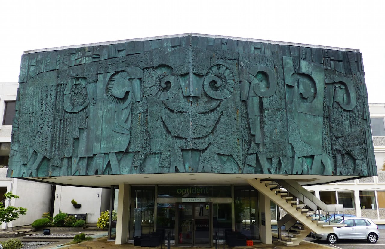 The Story of Wool by William Mitchell, 1968. International Development Centre, Valley Drive, Ilkley, West Yorkshire. Listed Grade II This is a stylised flock of sheep complete with careful detailing of their curled horns, cloven hooves and thick fleeces. It was made from glass reinforced plastic, a material the artist William Mitchell pioneered as a cheaper, lighter alternative to bronze. This was commissioned for the new Technical Centre of the International Wool Secretariat, an organisation established to promote the use and trade of wool in response to the increased use of synthetic fibres in the 50s and 60s. The centre was built in 1968 in Ilkley, as West Yorkshire was the main centre of the British woollen textile industry. © Historic England