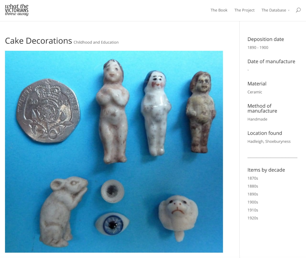 Victorian cake decoration thrown away between 1890 and 1900, including "Frozen Charlottes." (The site notes that the "two dolls’ eyes obviously were not decorations.") (screenshot by the author for Hyperallergic)