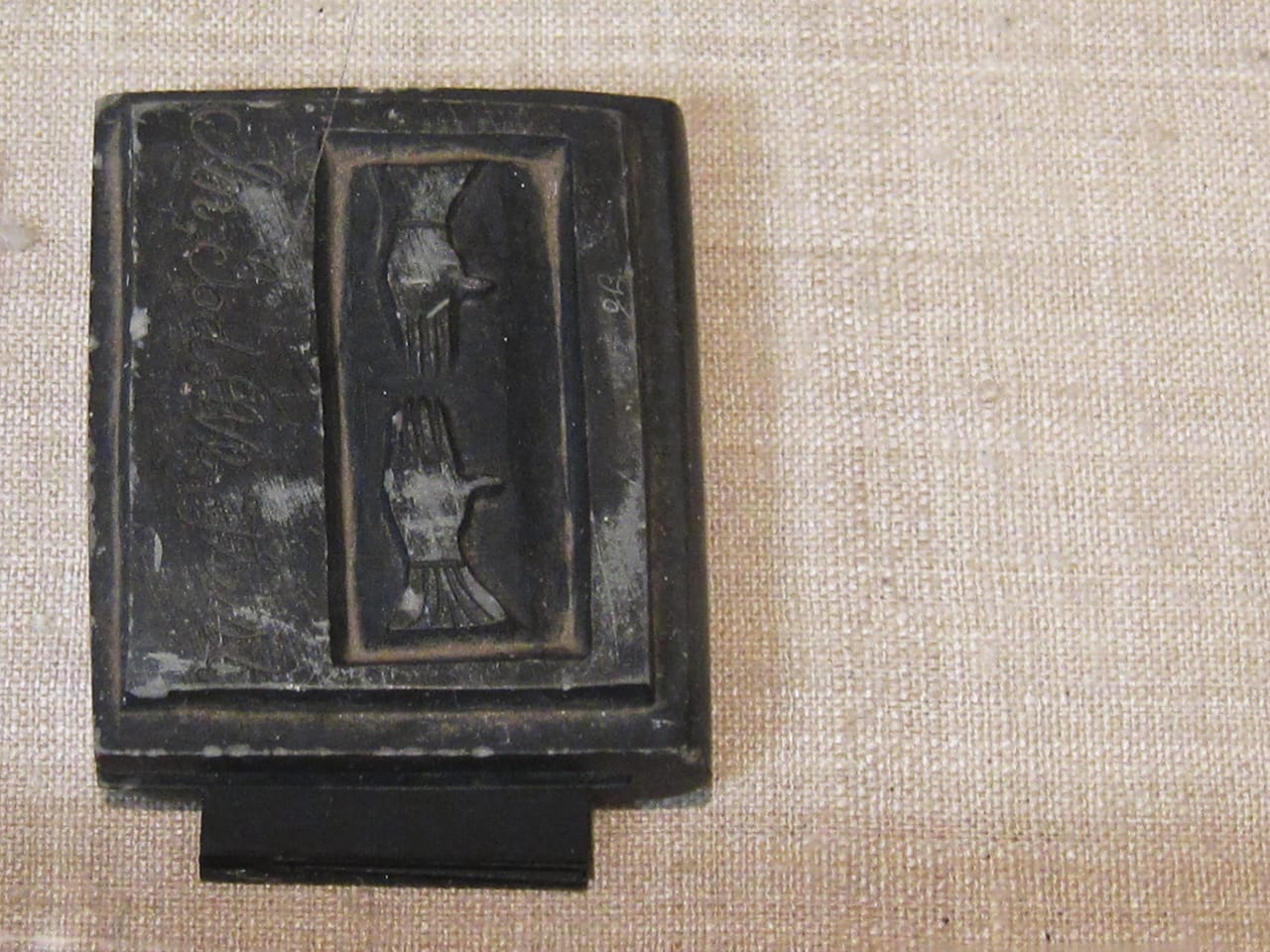 Hand-carved slate memorial book, inscribed with "In Memory" on the spine and "In, God. We, Trust" on the cover