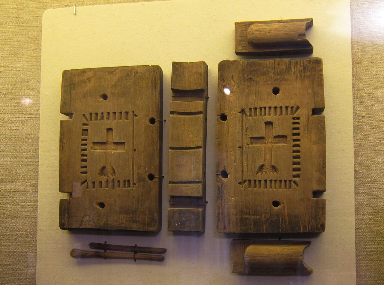 A carved maple sugar mold in the shape of a bible, likely meant for a communal holiday meal or funeral (c. 1820s)