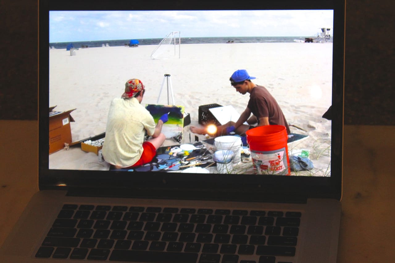 Crissman and Poe painting by on the Florida seashore (video on display at Trinosophes)