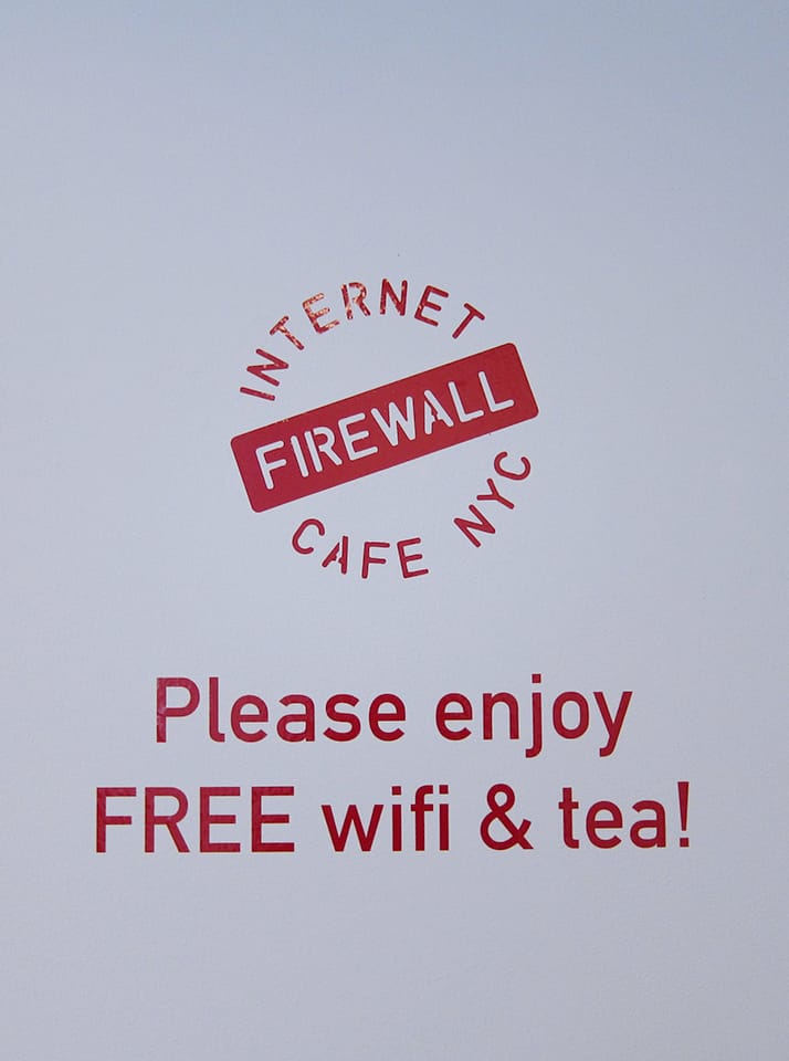 A sign inside FIREWALL Internet Cafe (click to enlarge)