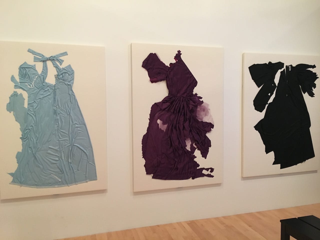 Dresses from Charlotte Moorman's "Cut Piece" performances installed in 'A Feast of Astonishments' (photo by the author for Hyperallergic)