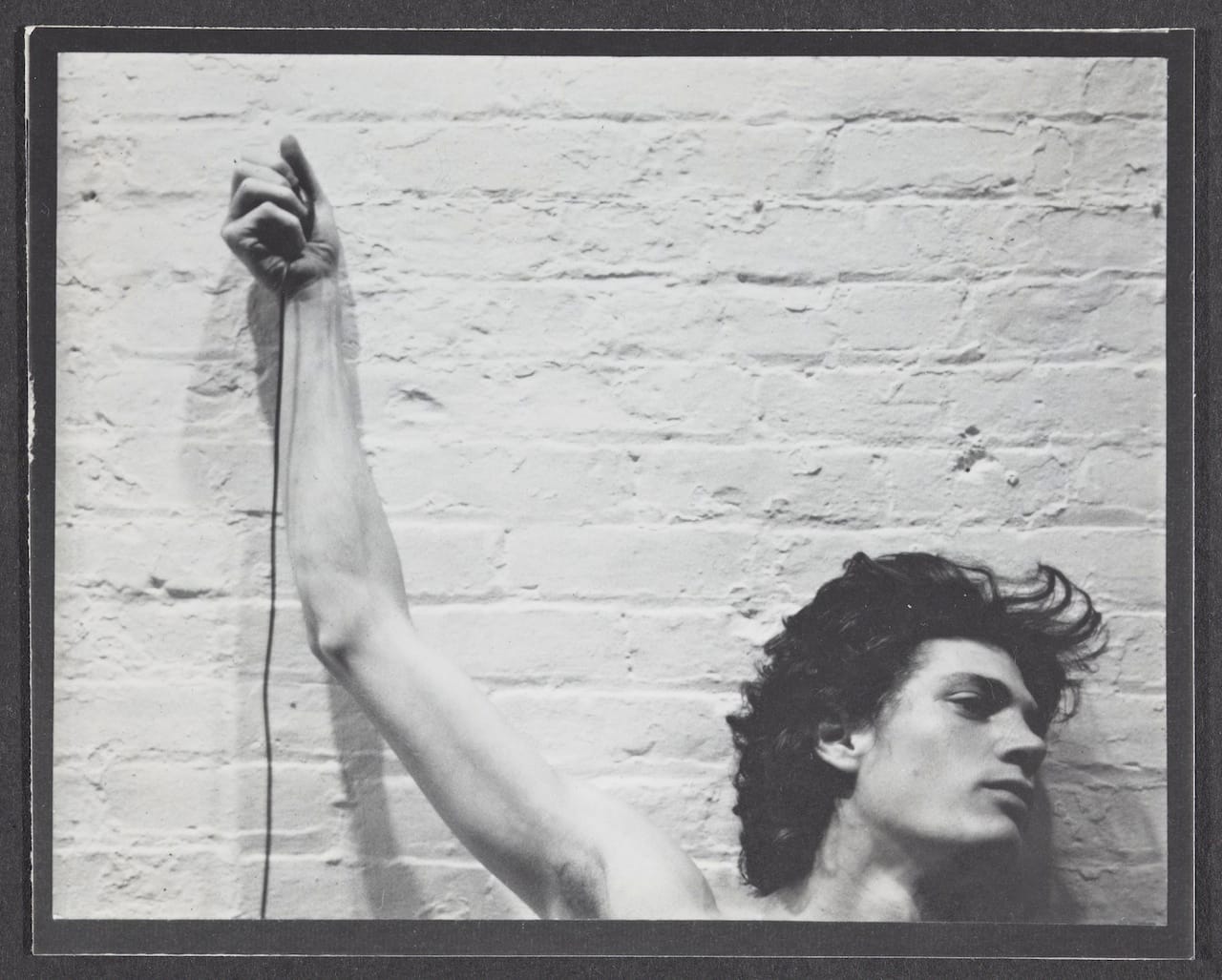 Robert Mapplethorpe," Self-portrait of Robert Mapplethorpe with trip cable in hand" (1974), Gelatin silver print, Sheet (each): 3 11/16 x 4 9/16 in. (© Robert Mapplethorpe Foundation, via getty.edu)