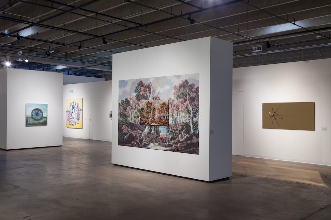 Installation view of 'Monumental' at RedLine with, at center, Suchitra Mattai, "Her earthly gains," embroidered needlepoint, 42 x 26 in mounted on a 10 x 6.2 ft pixelized print