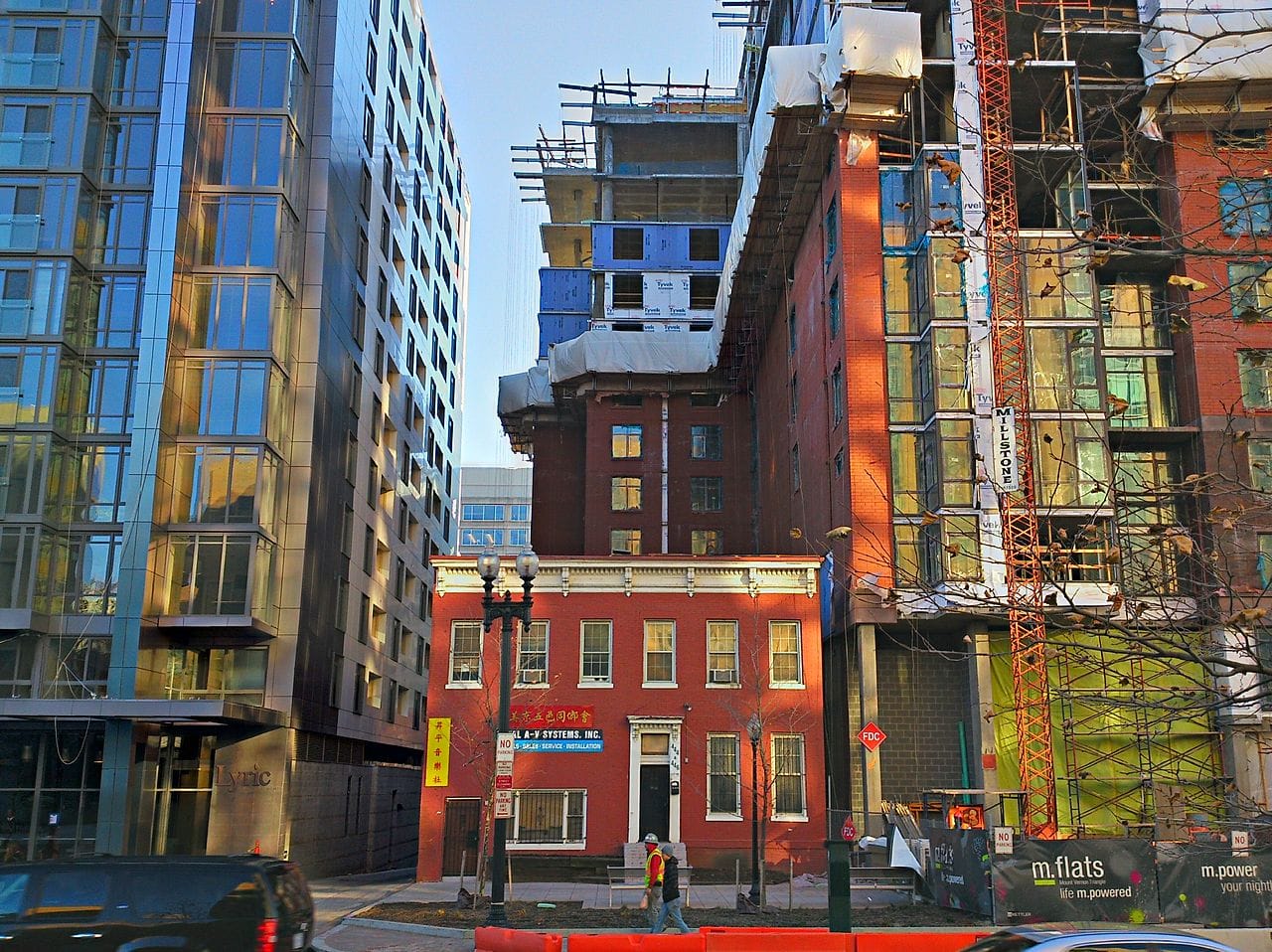 A 19th-century structure surrounded by construction in Washington, DC (photo by Payton Chung/Wikimedia)