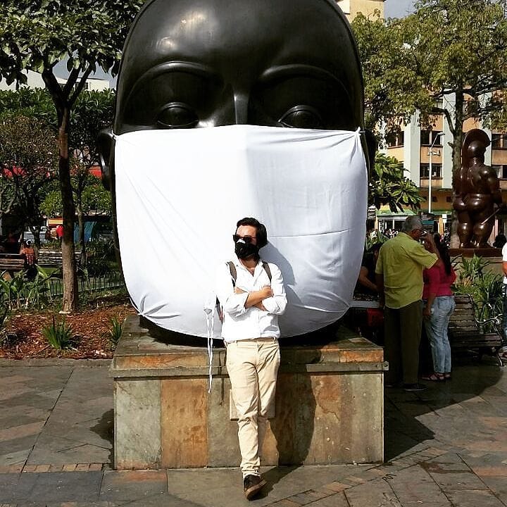 Carlos Cadena Gaitán of La Ciudad Verde poses in front of a masked Botero (photo via @cadenagaitan/Instagram)