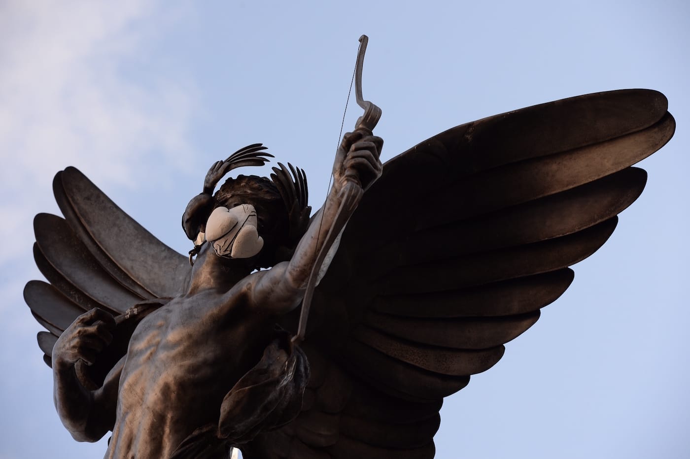 The Eros statue in Piccadilly Circus with an emergency face mask (photo by Chris Ratcliffe)