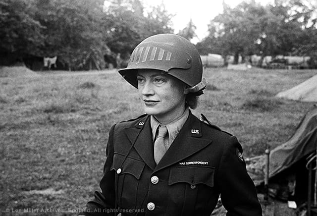 Lee Miller in steel helmet specially designed for using a camera, Normandy, France, 1944, by unknown photographer (© The Penrose Collection, England 2015)
