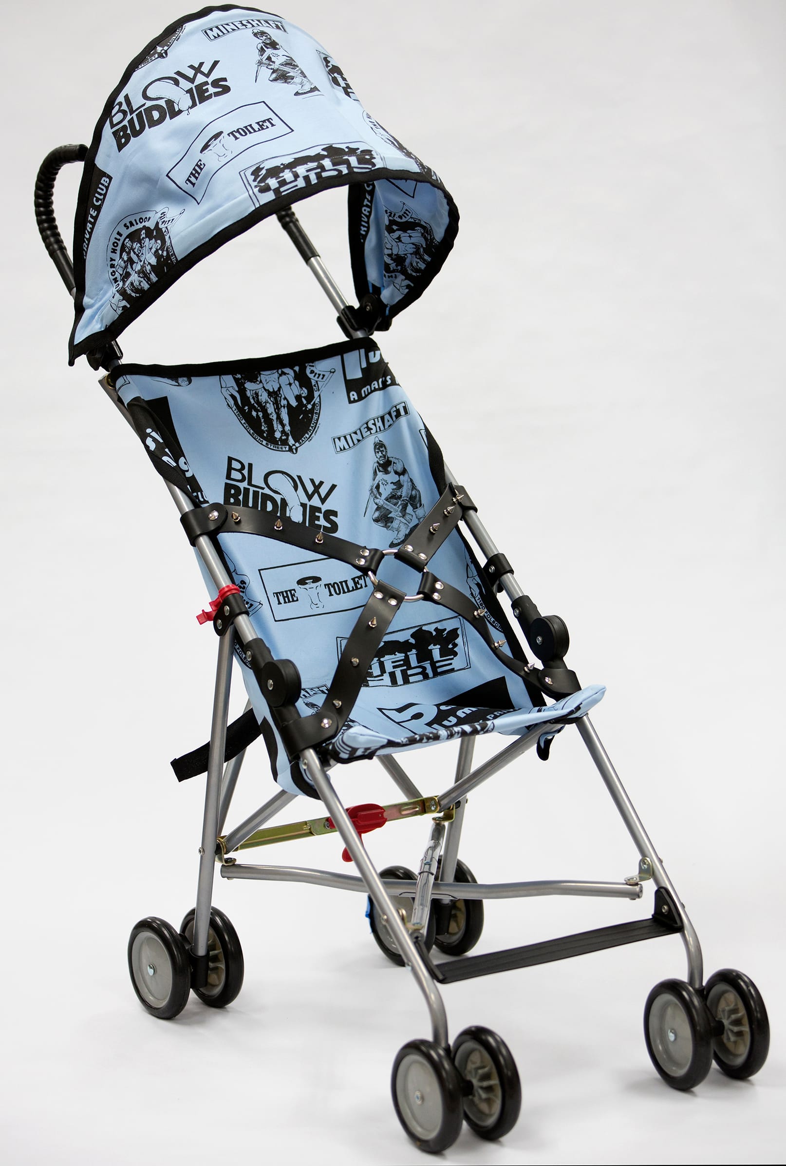 John Waters, "Bill’s Stroller" (2014), umbrella lightweight stroller with silkscreened linen and spiked leather belt, 34 x 14 x 26 inches (click to enlarge)
