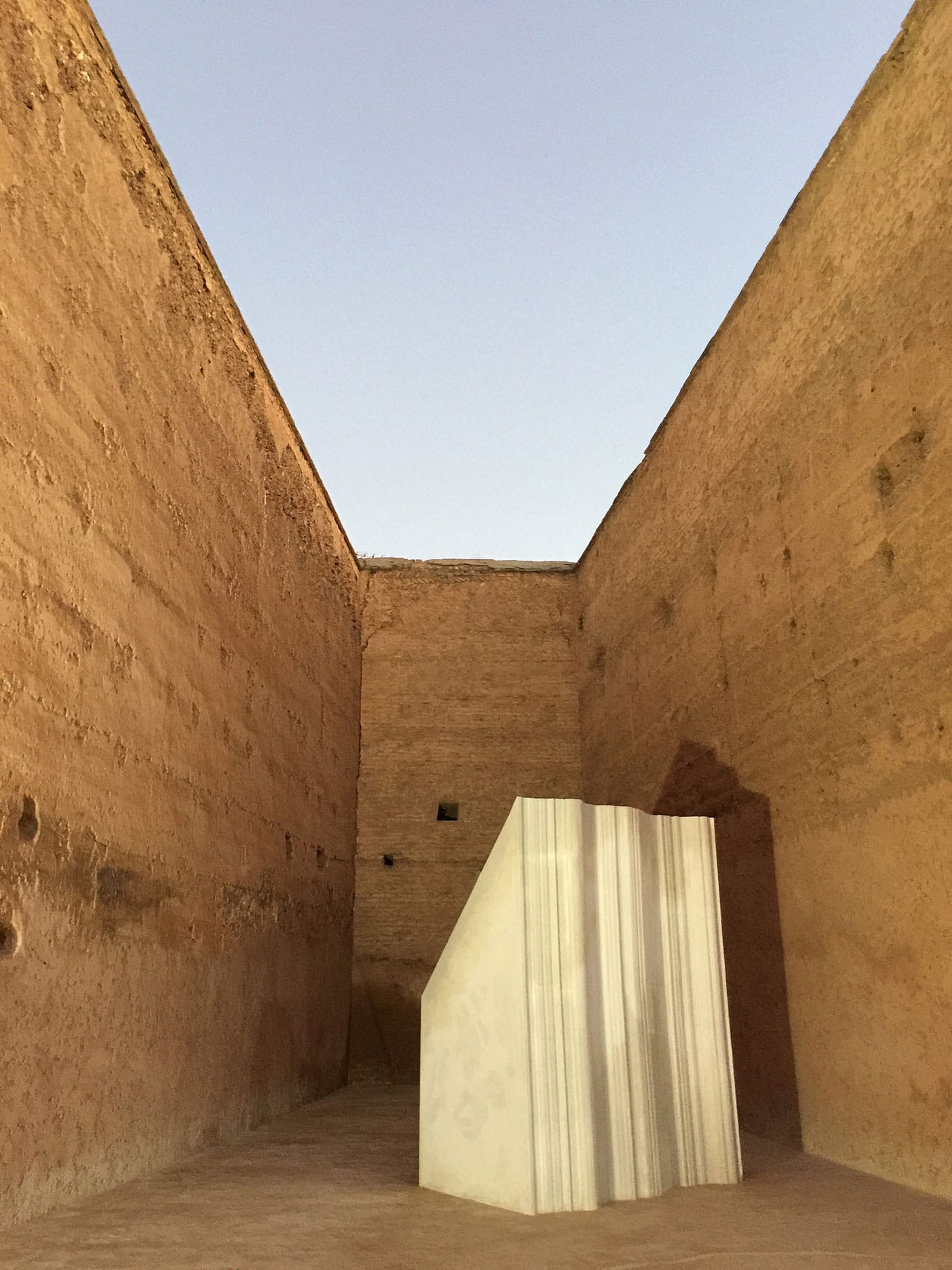 A sculpture by Saba Innab against the walls of Badii palace.