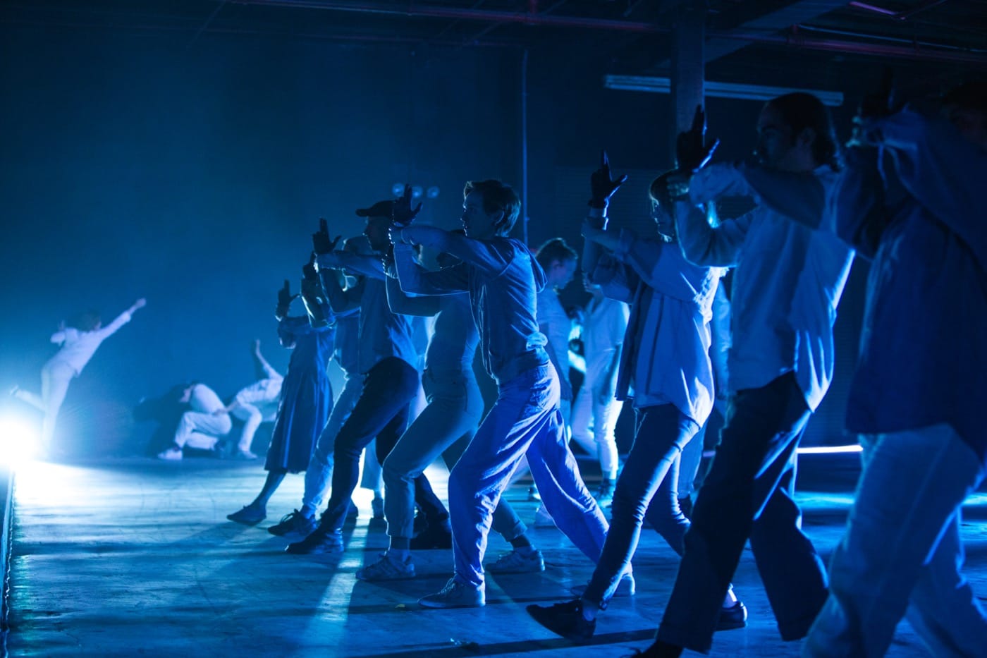 A scene where black-gloved hands are pretend guns