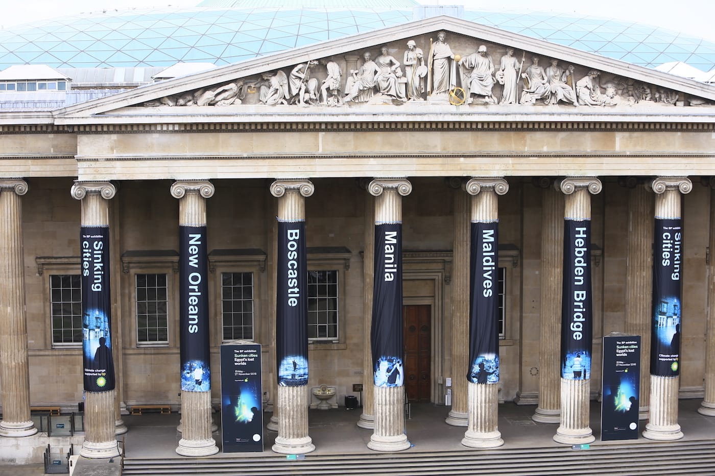 Greenpeace activists climb the British Museum in protest at BP’s sponsorship of a new exhibition ‘Sunken Cities’. The climbers unfurl seven huge banners down the front columns of the British Museum. The banners carry the names of cities and regions struck by flooding and climate change disasters.