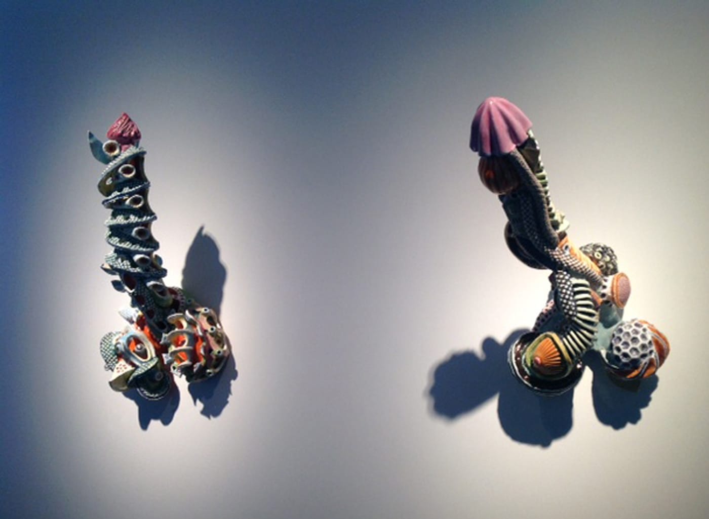 Michel Gouery, Ray Gun n°2" (2015, left) and "Biomécanopatère" (2012, right) (photo by the author for Hyperallergic)