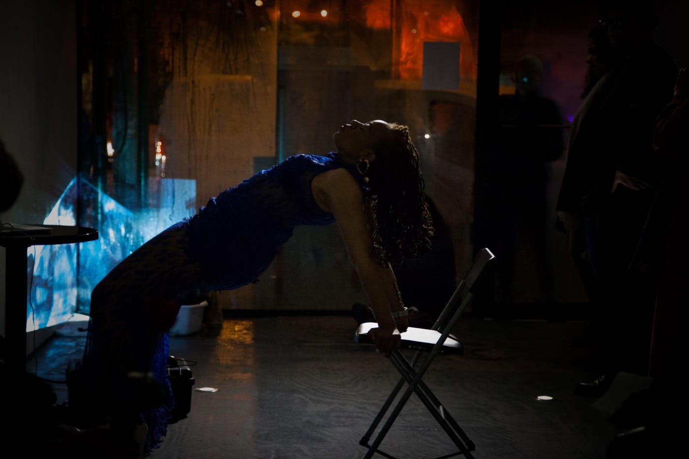 Ayana Evans doing chair dips in the gallery. Photo by Ventiko