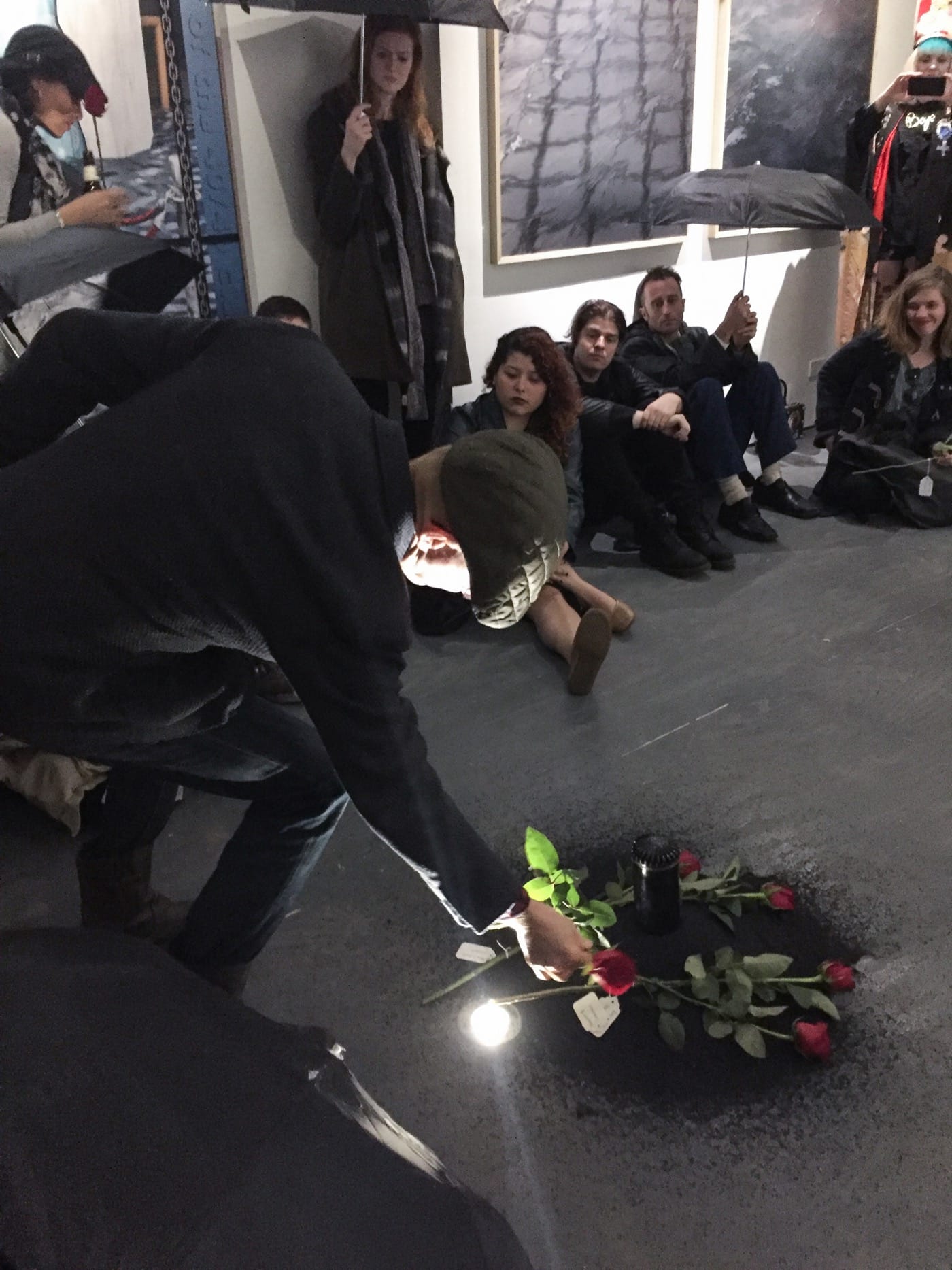 During Butz' performance audience members lay flowers on an earthen mound. Photo by Ventiko