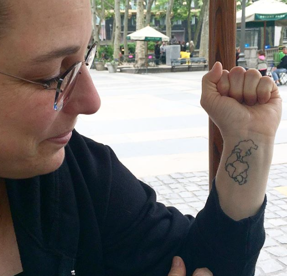 Tania Bruegera showing her Pangaea tattoo during our interview in Bryant Park.