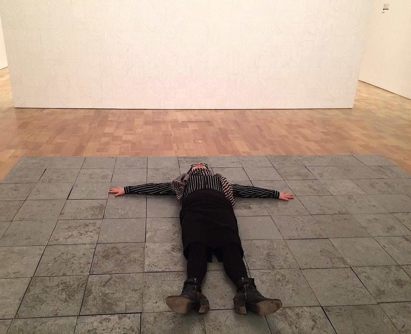 The writer lying on Carl Andre’s “144 Pieces of Zinc” (1967) at the Milwaukee Art Museum (all images courtesy the author)
