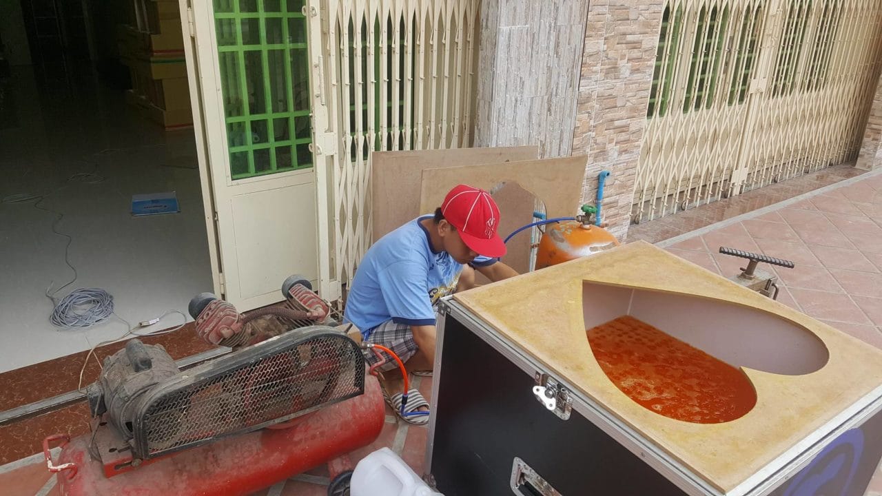 Staff member prepares the foam printing machine.