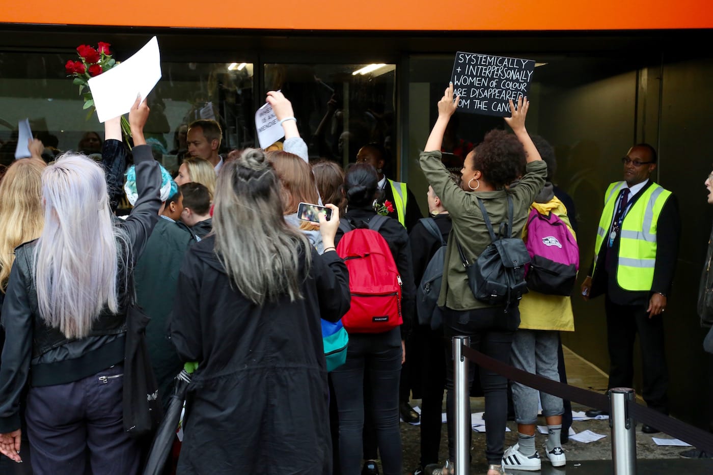 Protesters pressing their signs and bodies against the windows of the Turbine Hall