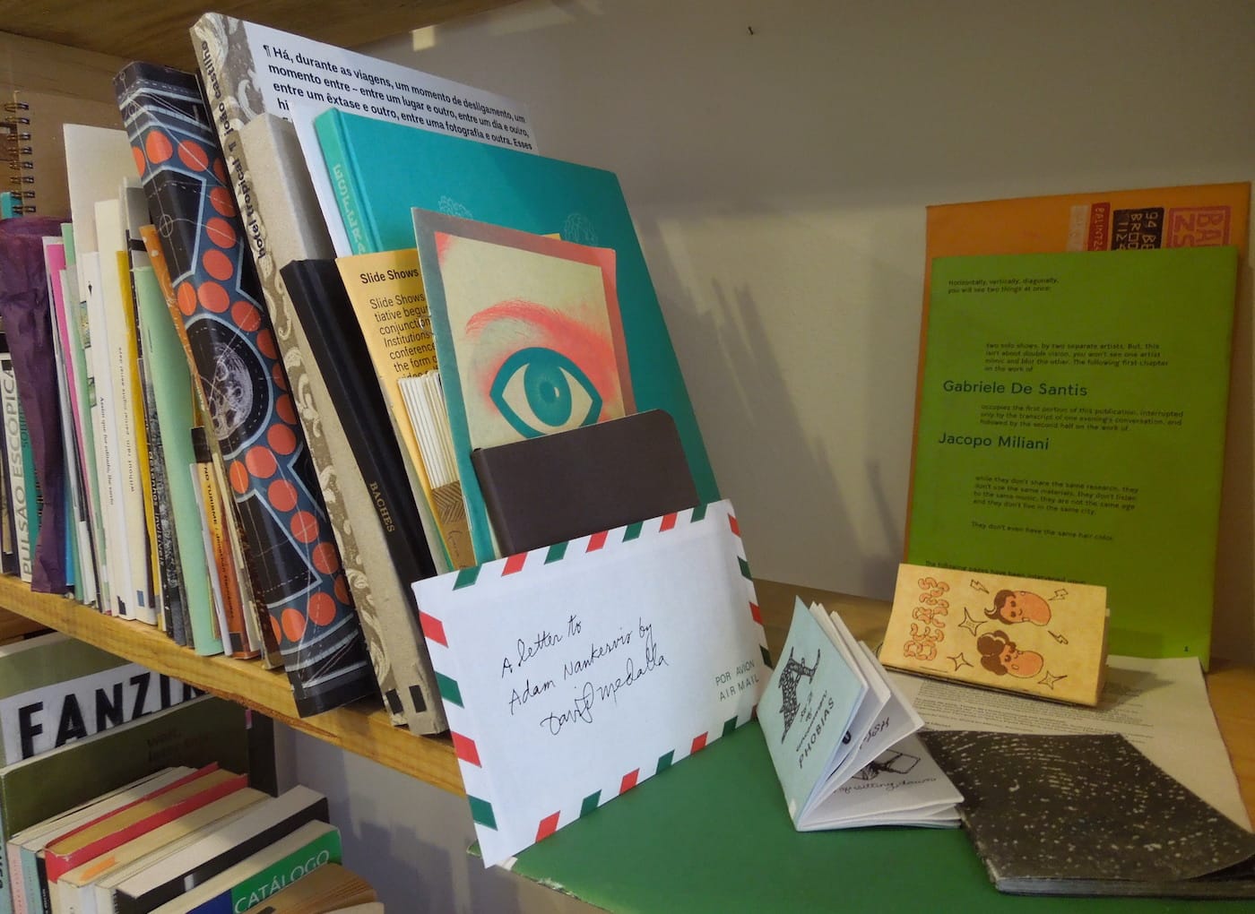 Books, zines, and mail art on the shelves at Aeromoto