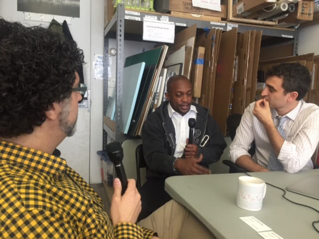 The author interviewing artists Hank Willis Thomas and Eric Gottesman. (photo by Gisele Rigatao for Hyperallergic)